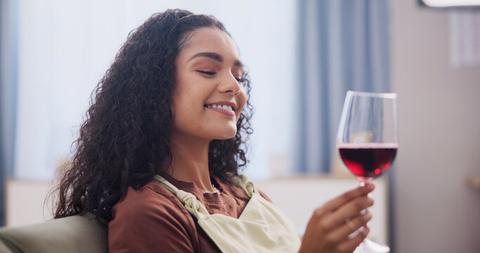 Break, taste and wine with happy woman on sofa in home living room for test of homemade beverage. Glass, relax and smile with person drinking alcohol in apartment for satisfaction or winemaking hobby