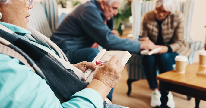Hands, old woman and reading at house with crossword, word search and quiz for health. Senior person, writing and book in home with sudoku games, problem solving and puzzle activity for brain teaser