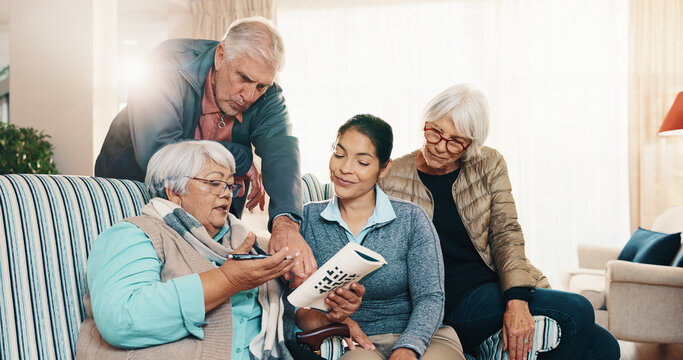 Caregiver, old people and reading at house with crossword, word search and quid for healthcare. Nurse, help and senior group in home with sudoku, problem solving and puzzle activity for brain teaser