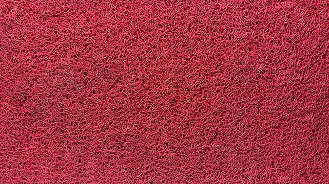 Red rubber mat with rough and thick texture or keset kaki in Indonesia as one of the home interiors. Top view, high angle, above, flat lay. copy space, empty, free, negative, text, design. background,