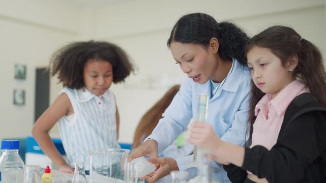 Young students girls in a lab setting. They wear lab coats and focus on experiments. Teacher guides them with hands-on support. Curious expressions show engaged learning. Ideal for education, science