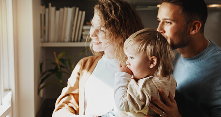 Obraz premium Window, smile and family in home for bonding together, connection and support with baby child. Mother, father and toddler in house with care, love and view with happy parents on weekend break