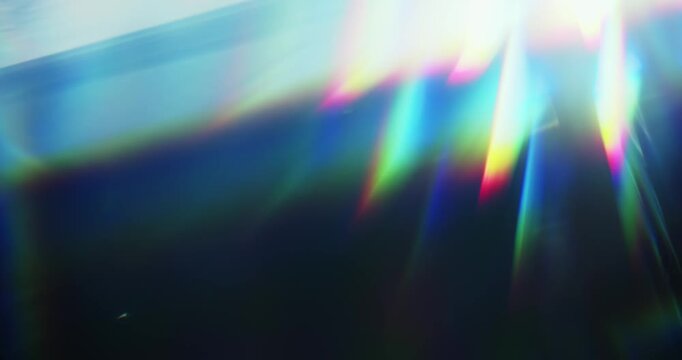 Light reflect burst illuminating the brilliance of a reflective prism. Radiant lighting creating a visual effect of light refraction in a rainbow colors and a dreamy rays of lights background. Loop