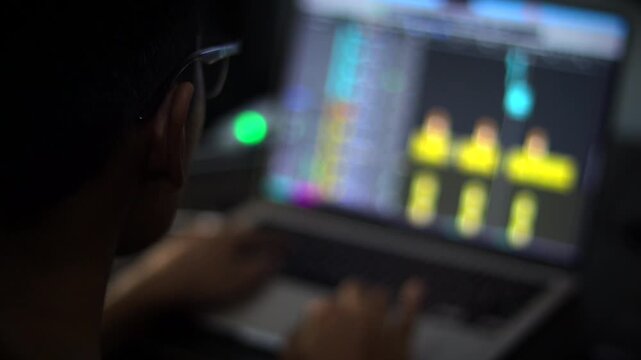 Audio Engineer Working with Digital Audio Workstation on Laptop Computer