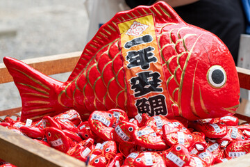 Red Tai Fish Decoration with Lucky Charms at Japanese Shrine © Amane