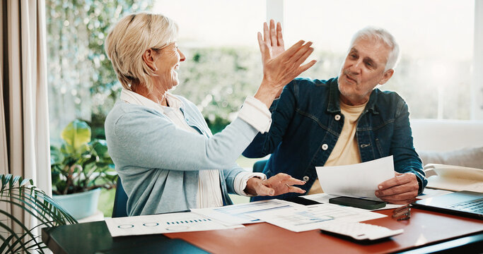 Paperwork, finance and senior couple high five for budget planning, mortgage payment and success. Celebrate, marriage and happy man with woman with savings, financial report and loan approval in home