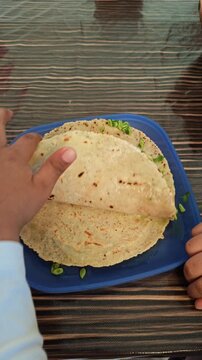 making a taco with tortilla and guaje green salsa