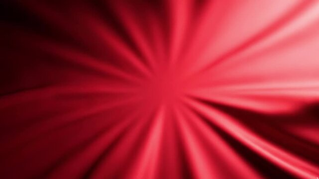 Abstract red background with radial light beams and soft glowing sunburst effect