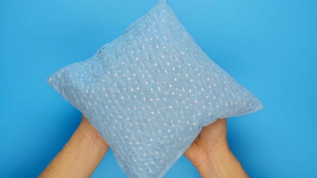 Textured pillow gently fluffed in bright studio lighting for home decor advertising