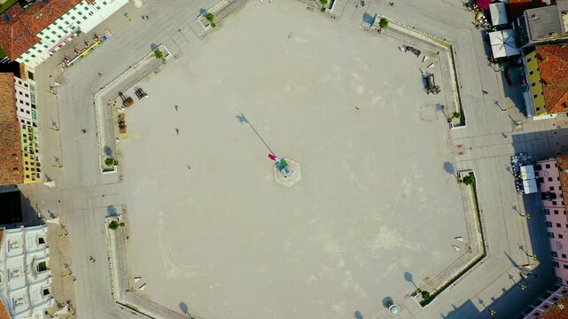 Palmanova, Udine, Italy. The perfectly symmetrical nine-pointed star fortress, its hexagonal Piazza Grande and radiating streets visible from a vertical drone perspective under bright summer sun. Dro