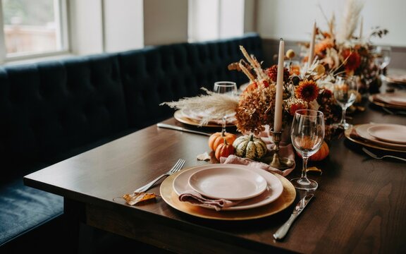 Elegant rustic dining table setting decorated for a festive thanksgiving day celebration with autumn harvest decor