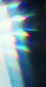 Light reflect burst illuminating the brilliance of a reflective prism. Radiant lighting creating a visual effect of light refraction in a rainbow colors and a dreamy rays of lights background. Loop