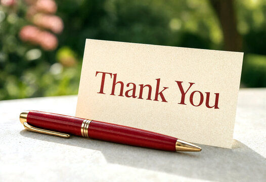 Elegant thank you card with a red pen on a table showing gratitude and appreciation