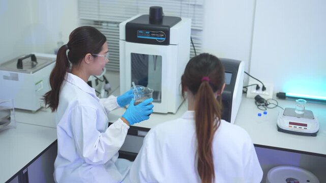 Scientists collaborate in a modern laboratory conducting chemical research, data analysis and experiments, innovation, biotechnology, healthcare and science.