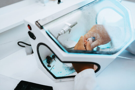 Nail Technician Manicure Using Electric Drill Inside Dust Collector During Acrylic Nail Shaping