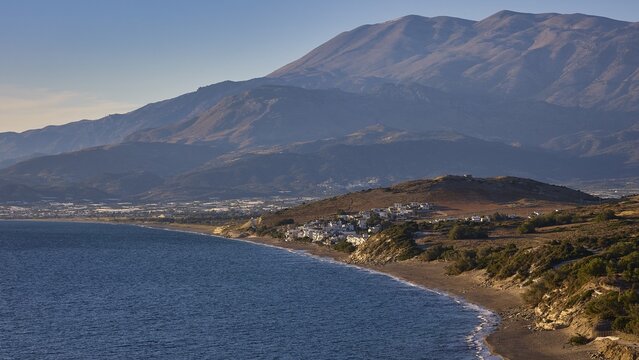 Komos Beach, coastal landscape with mountains in the background and a small settlement along the sea, Matala, south coast, Crete, Greek Islands, Greece