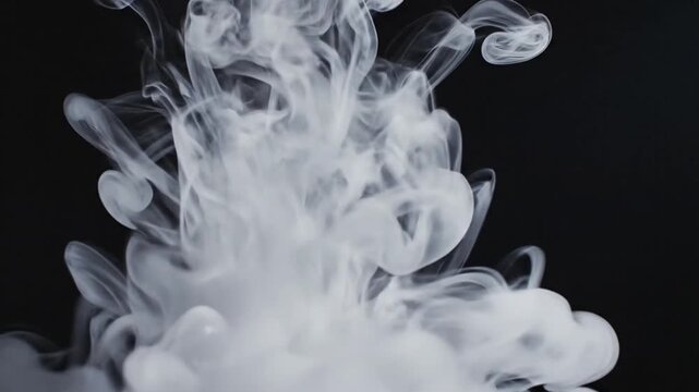 White smoke or ink plume rising and swirling gracefully in a dark liquid, creating abstract, ethereal patterns and textures.