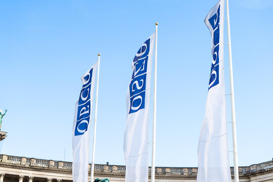 OSCE white on blue background. Neue Burg Wing and Kunsthistorisches Museum View with OSCE Flags at Heldenplatz Square. Vienna, Austria - June 21, 2026