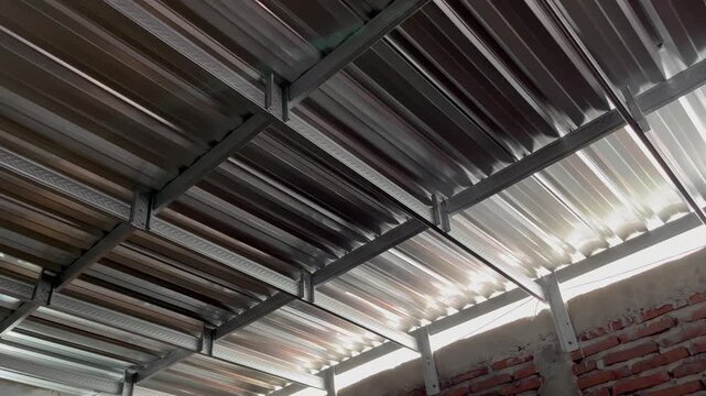 Cinematic sunlight and deep shadows on corrugated galvalume roof panel