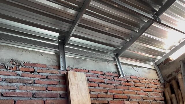 Unfinished residential concrete beam with wooden formwork and steel roof truss
