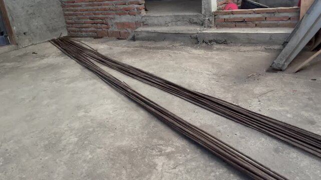 Bundle of steel reinforcing rebars on active building construction site