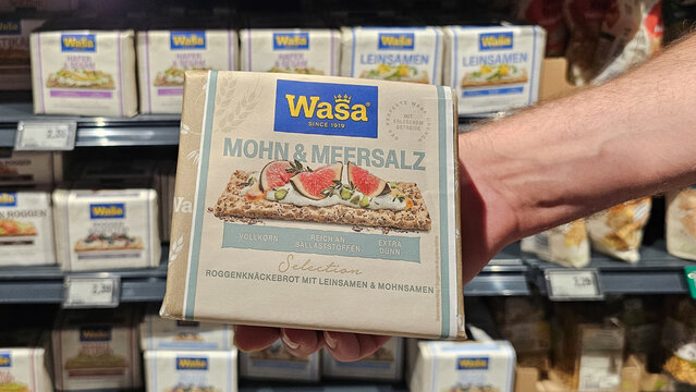 Hand holding wasa crispbread mohn & meersalz in grocery store