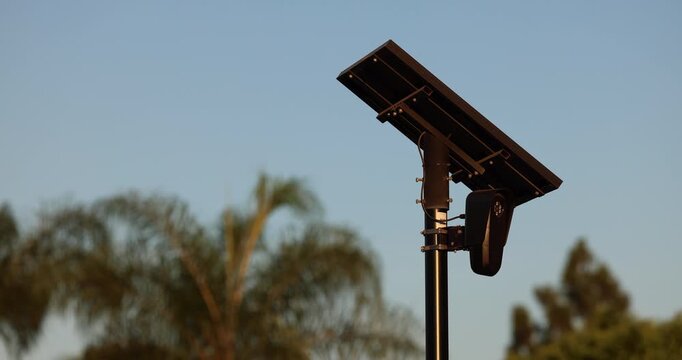 Fullerton, California, USA - July 23, 2026: An AI camera surveils a city street for car license plates.