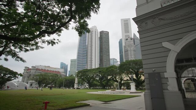 Sir Stamford Raffles Monument beside Victoria Concert Hall highlighting colonial heritage and elegant architecture in Singapore city for tourism across Asia
