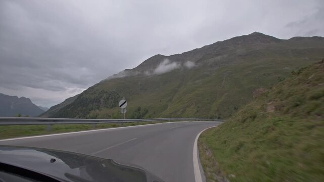 Scenic drive through the Austrian Alps with panoramic mountain views from a moving car showcasing the natural beauty of Tyrol and European travel tourism