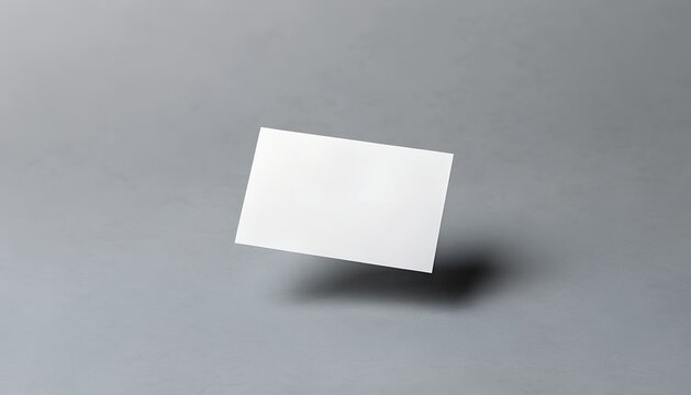 Blank White Rectangular Business Card Floating On A Soft Grey Background With Subtle Natural Shadows
