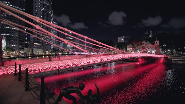 Night view of Cavenagh Bridge crossing the Singapore River with illuminated architecture vibrant skyline and unforgettable urban travel experience in Asia