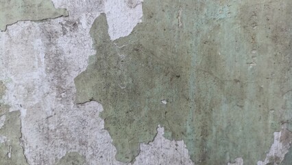 Obraz premium Peeling Green Paint Texture Background showing a distressed aged wall with exposed white plaster and worn green coating, ideal for grunge art, vintage designs, and rustic backdrops