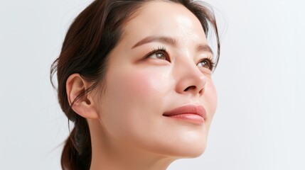 Obraz premium Close up profile of a young asian woman with clear glowing skin