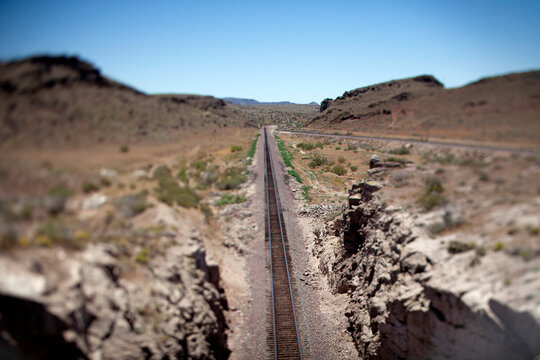 Long straight train tracks into the desert horizon