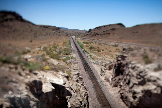 Miniature effect train tracks in a desert canyon