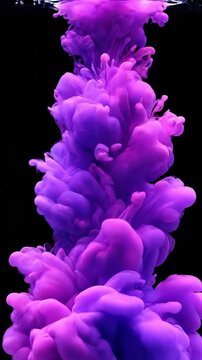 Ink droplet exploding into water. Abstract liquid paint cloud swirling in clear liquid.