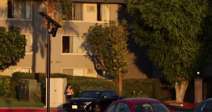 Fullerton, California, USA - July 23, 2026: An AI camera surveils a city street for car license plates.