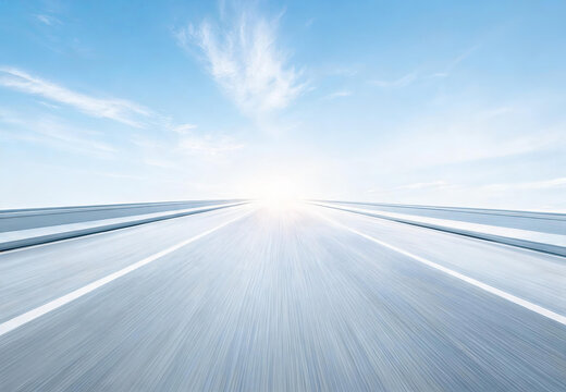 A long empty highway stretches toward a bright sunrise under a clear blue sky, with motion-blurred road lines emphasizing speed.