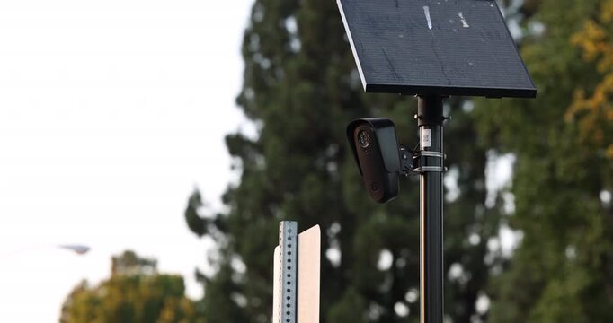 Fullerton, California, USA - July 23, 2026: An AI camera surveils a city street for car license plates.
