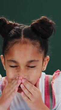 Sick, child and girl in studio with sneeze, sinus infection and health issue with hayfever symptoms. Kid, allergy and medical problem with flu virus, nasal irritation and illness on green background.