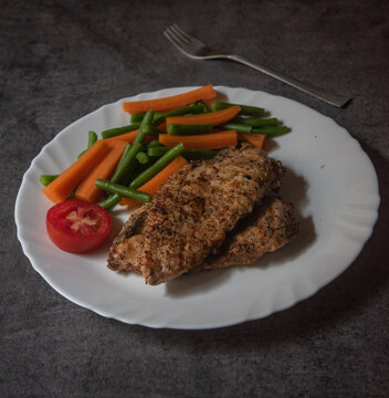 Grilled chicken steak and vegetables. Close up.