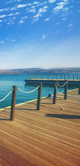 Fototapeta premium Wooden pier in the sea. Sea of Galilee, Capernaum, Northern Israel
