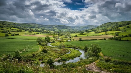 Obraz premium Green farmland in a valley with a winding river. Scenic rural landscape with rolling hills.