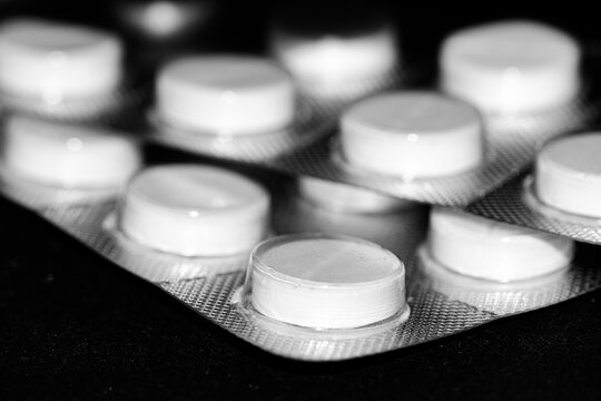A blister pack of white paracetamol pills tablets with isolated on a neutral background