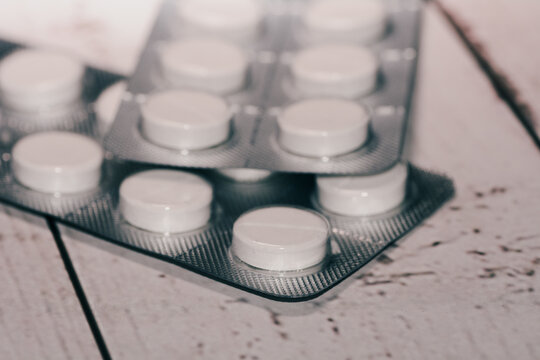 A blister pack of white paracetamol pills tablets with isolated on a neutral background