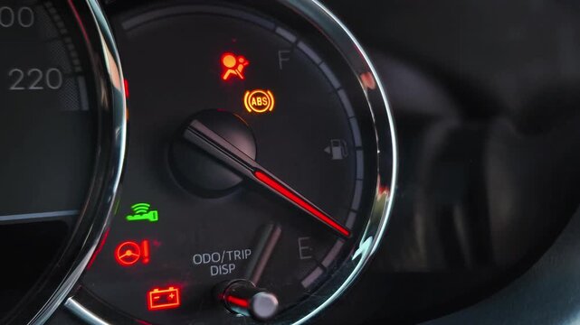 Car dashboard warning lights illuminated during engine start with airbag, battery, power steering and smart key indicators