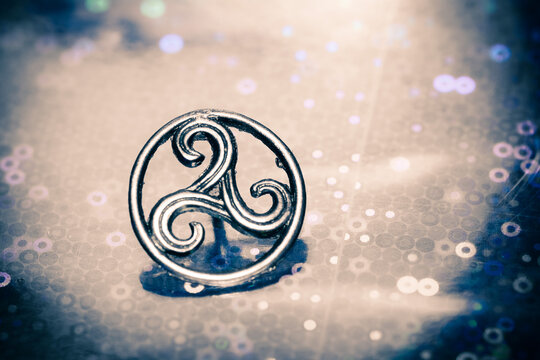 Metal triskel symbol representing motion, balance and Celtic spiritual heritage