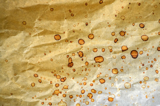 Vintage parchment paper texture with scattered stains, wrinkles and aged surface. Rustic background ideal for retro, editorial and design projects.