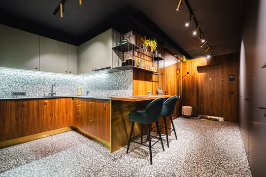 Terrazzo flooring and walnut cabinetry in open kitchen area