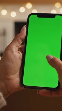 a hand holding and scrolling on a smartphone with a bright green screen above an unboxed retail package. Designed for e-commerce platform demos, mobile shopping app promotions